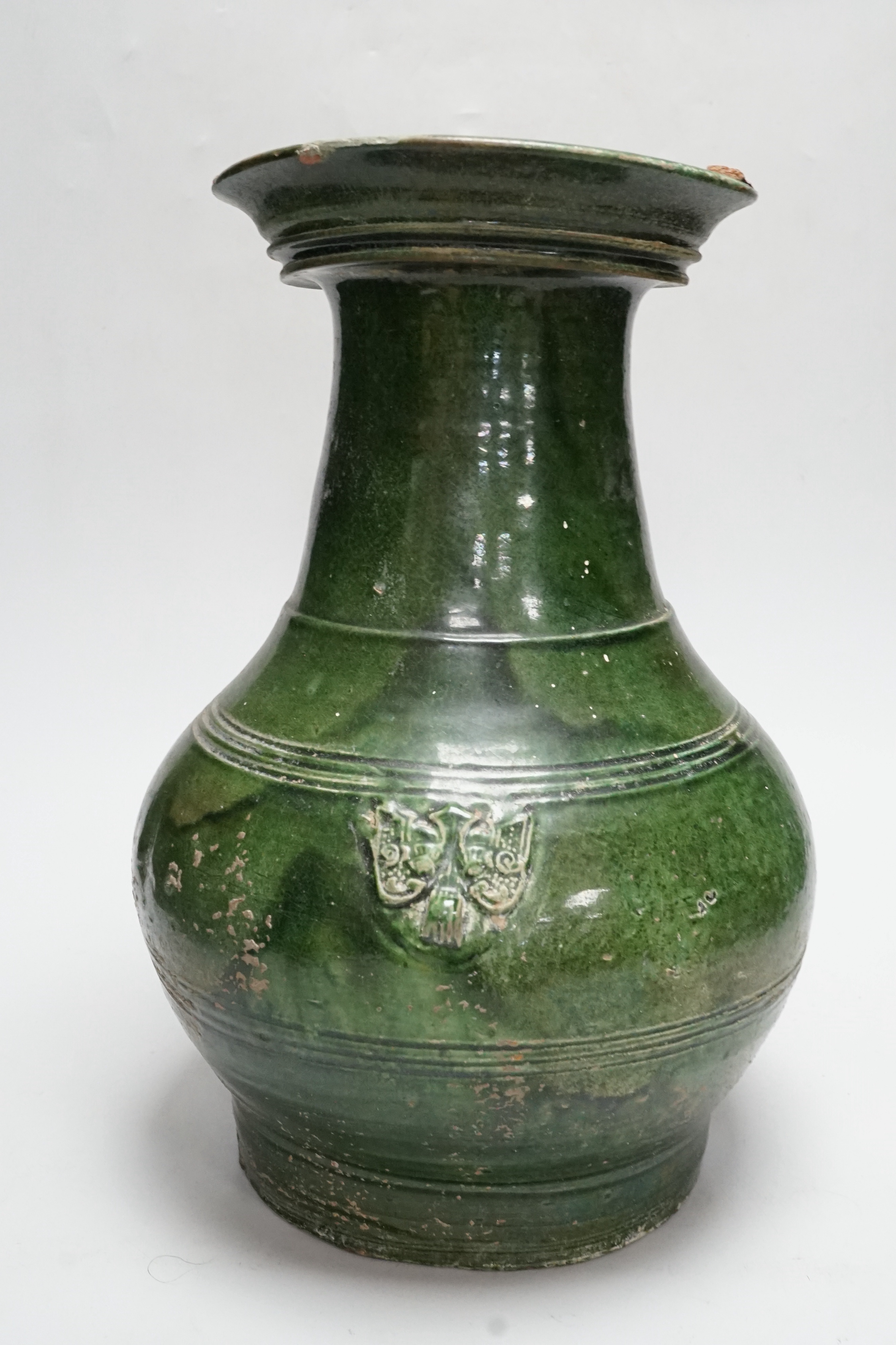 A Chinese Han dynasty dark green glazed ribbed baluster vase, hu, 34cm